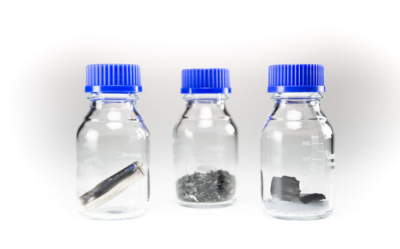 Photo of scrap battery materials in sample bottles